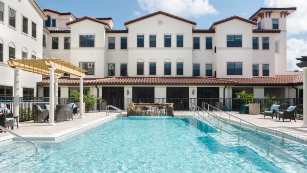 American House Senior Living Communities exterior building with swimming pool