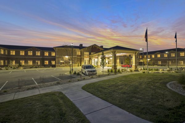 Exterior building front of Crescent Senior Living at dusk